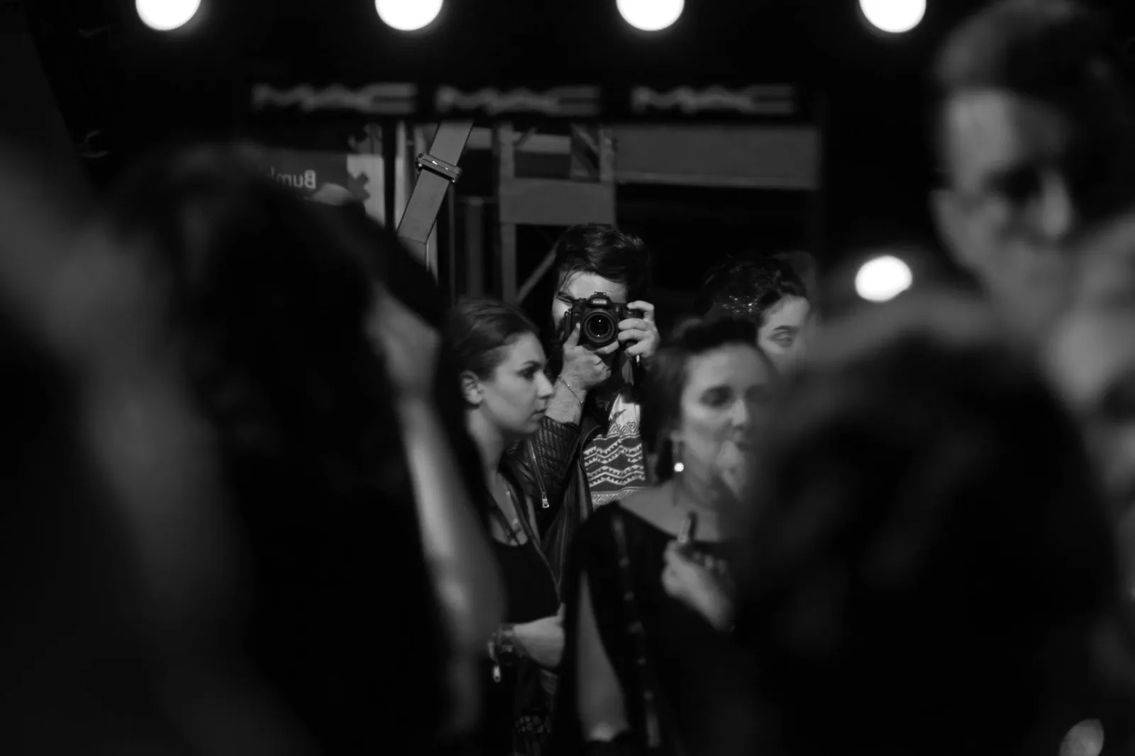 Behind the lens at a creative agency in Qatar: photographer at work in a crowd